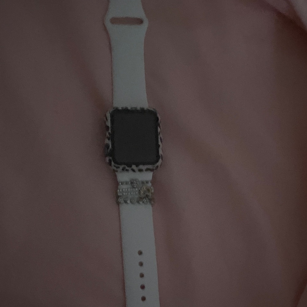Stylish White Apple Watch with Decorative Band
Comes with box and charger.